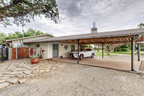 Carport  Steel supports, Stained concrete reclaimed beams, custom iron turnbacks, Custom antler chandeliers, spot lighting, Security system 13 cameras, gutters with leaf guards.