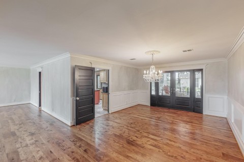 Dining room view 2 with double french doors to access covered patio pool and outdoor kitchen