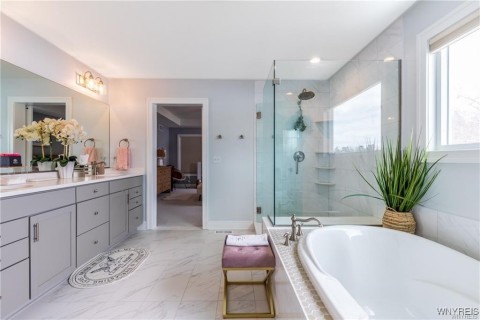 Ensuite bath, separate tile shower with bench, soaking tub. Heated Floors!