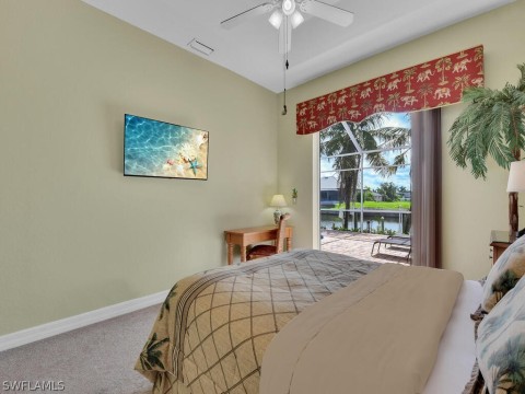 Bedroom with ceiling fan, carpet floors, a water view, and access to exterior