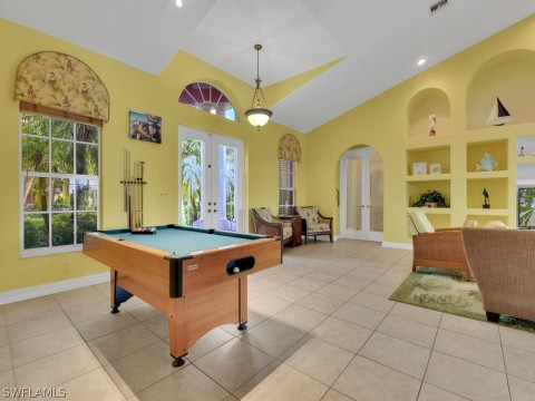 Recreation room with light tile floors, french doors, billiards, and a wealth of natural light