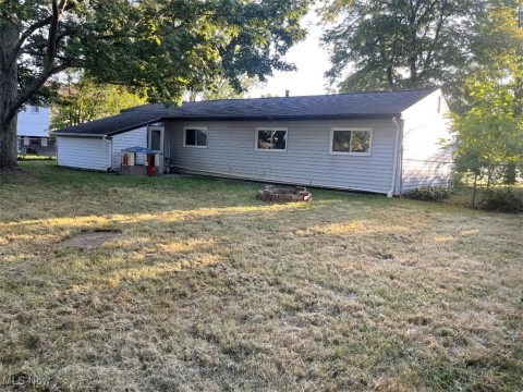 Rear view of house with a yard