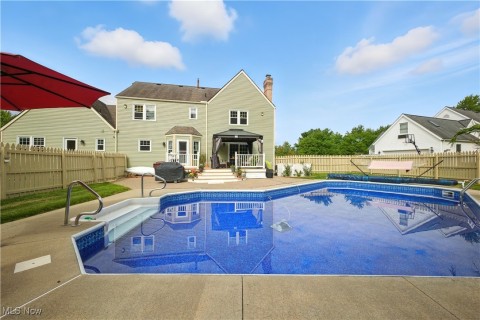 View of pool with a patio area, a gazebo, and a fenced backyard