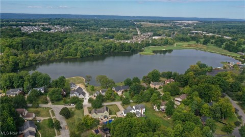 Aerial overview of property's location featuring a large body of water and nearby suburban area