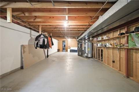 Unfinished below grade area with gas water heater and heating unit