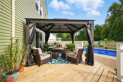 Deck featuring a gazebo and an outdoor living space