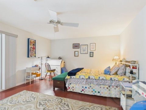 Bedroom featuring ceiling fan and wood finished floors