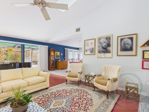 Living room featuring a cathedral ceiling with skylights