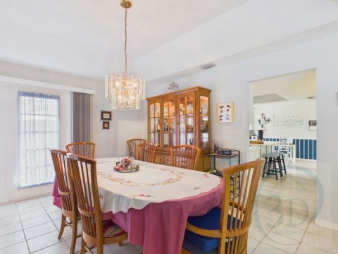 Dining room with light tile patterned floors and hanging lights