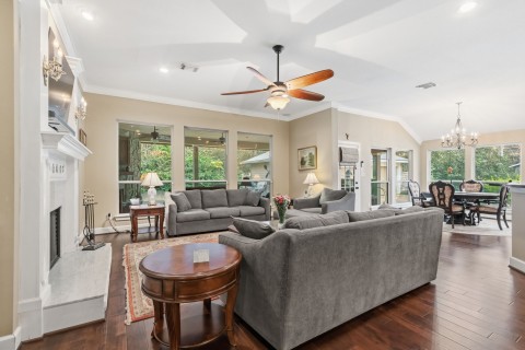 The family room is conveniently situated off the kitchen which provides an open feel to these rooms. Large windows overlook the covered patio and pool. Cozy fireplace for those cold days. Lighted built-ins are featured and are the perfect place to display your art pieces and pictures.