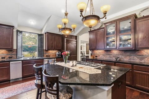 Well design kitchen is a chef's dream! Complete with glass front cabinets to display your dishes. A great breakfast bar for those meals on the go! Built-in refrigerator replaced 3/2025.