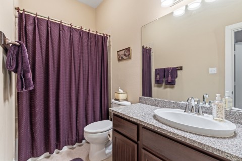 Charming ensuite bathroom for the secondary bedroom. Nice counter space and features a tub/shower combination.
