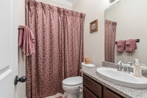 Charming ensuite bathroom with ample counter space and a convenient tub/shower combo, perfect for the secondary bedroom.