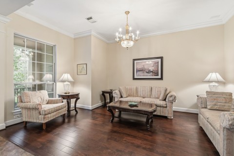 The large formal living room is another place to have long conversations with your guests. The chandelier is excluded from the sale.