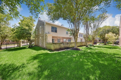 This view of the rear elevation highlights the beautiful landscaping which is maintained by the HOA.