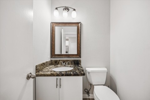 The guest bath also boasts the same granite on vanity conveniently located off family room.