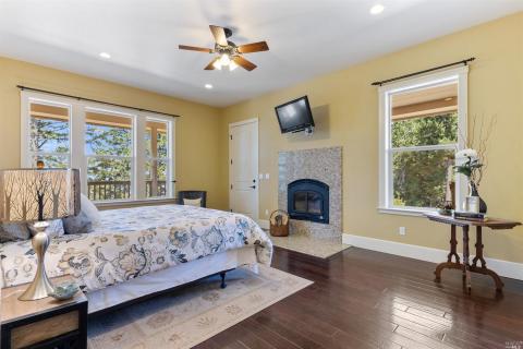 Primary bedroom is located on the main floor. Access to the wrap porch and luxurious en suite bath.