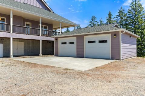 Detached 2 car garage with remote door openers. Easy exterior access to the basement, pictured left.