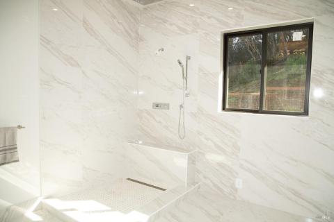Custom gloss tile work in the primary bath.
