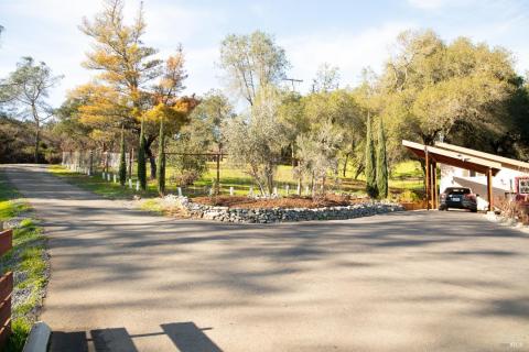 Beautiful setting of the road in and out of the property plus second home on the right.