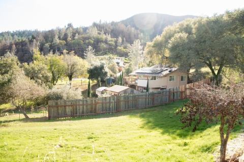 View from the street of the guest house (close up) to the custom home in the background.