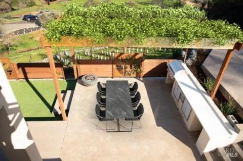 Pergola and outdoor kitchen right next to the pool.