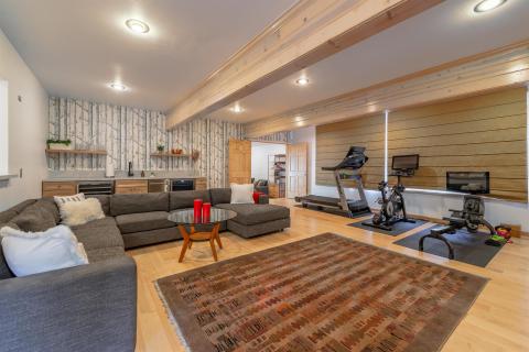 The room has a wet bar, area with a day bed and a full bathroom.