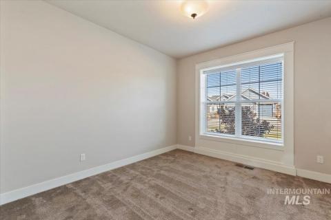 Carpeted empty room with baseboards