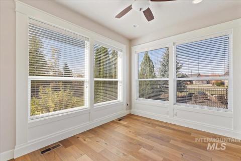 Office with light wood-style floors, plenty of natural light, a ceiling fan, and recessed lighting