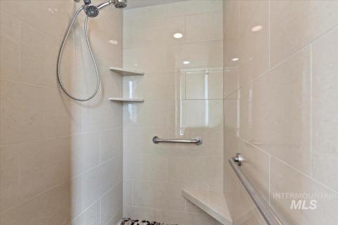 Full bath featuring tiled shower