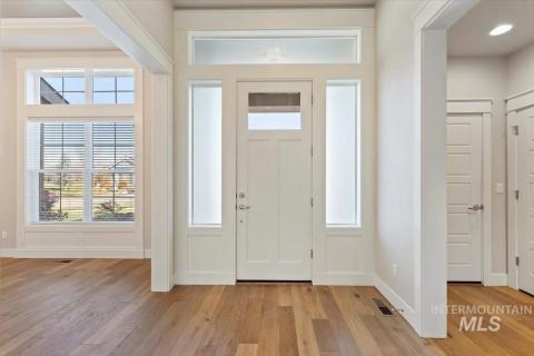 Foyer entrance featuring light wood finished floors and baseboards
