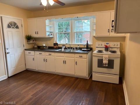 THE KITCHEN IS SO CHARMING.  FRESHLY PAINTED CABINETS, NEW HARDWARD AND NEWER WINDOWS.