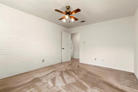 Primary Bedroom with painted brick accent wall.