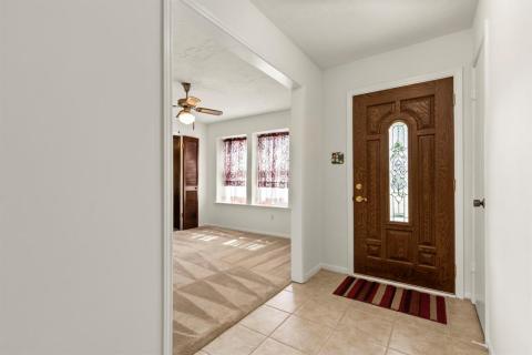Enter into the tiled Foyer.  Coat closet to the left if the door.  Formal Dining to the right of the door.