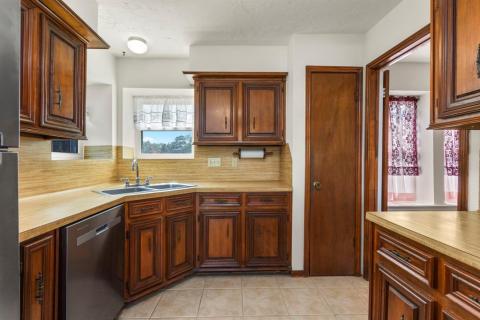 The Kitchen offers a corner sink.  New Whirlpool Stainless Steel Dishwasher.  Pantry.  Lots of cabinet and counter space.