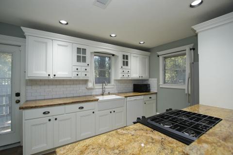 Darling kitchen that offers plenty of cabinets for storage, a farmhouse sink, cam lighting, and ample counterspace for meal prep. Darling kitchen that offers plenty of cabinets for storage, a farmhouse sink, cam lighting, and ample counterspace for meal prep.