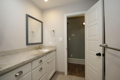 This bathroom features a modern design with stunning countertop, sink, and ample cabinet space. A large mirror is mounted above the sink, and the room is well-lit with recessed lighting. The neutral color palette adds to the clean and contemporary feel. This bathroom features a modern design with stunning countertop, sink, and ample cabinet space. A large mirror is mounted above the sink, and the room is well-lit with recessed lighting. The neutral color palette adds to the clean and contemporary feel.
