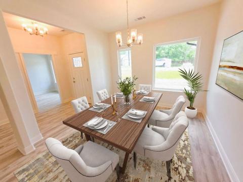 Dining area featuring a chandelier and light wood
