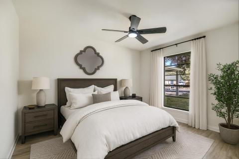 Bedroom featuring ceiling fan and wood finished f