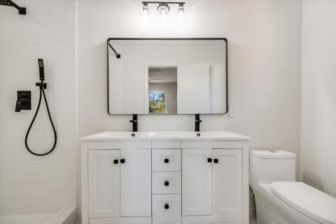 Bathroom with a tile shower and double vanity