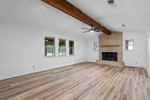 Unfurnished living room with light wood-style flo