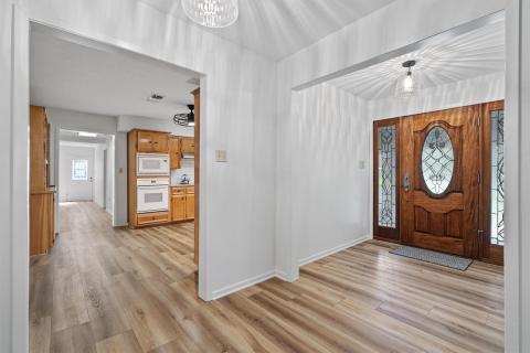 Entryway with light wood-style floors, baseboards