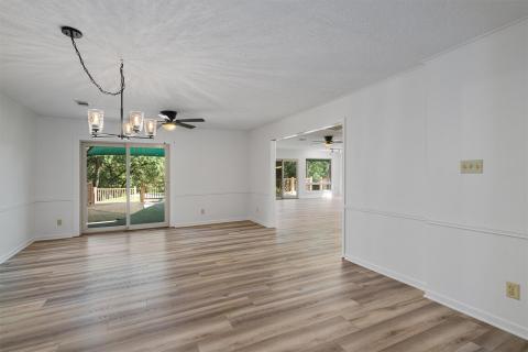 Spare room with a chandelier, plenty of natural l