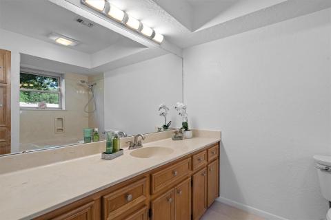 Full bath featuring toilet, a shower, vanity, and