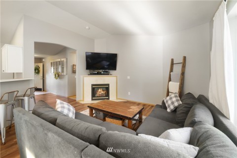 Room for the sectional couch to cozy up by the fire. 