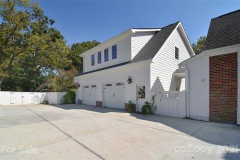 Oversized garage complete with work areas, drop zone, 1/2 bath, door to full apartment upstairs. One set of gates to enter breezeway to main house and garden area. Set of wide doors for mowers, event set-ups, etc. Oversized garage complete with work areas, drop zone, 1/2 bath, door to full apartment upstairs. One set of gates to enter breezeway to main house and garden area. Set of wide doors for mowers, event set-ups, etc.