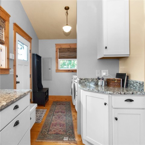 Utility room off of kitchen with added storage and side door to wrap around deck. Utility room off of kitchen with added storage and side door to wrap around deck.