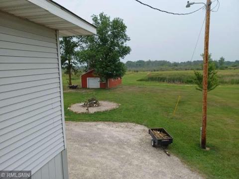East view with barn in back ground and fire ring.