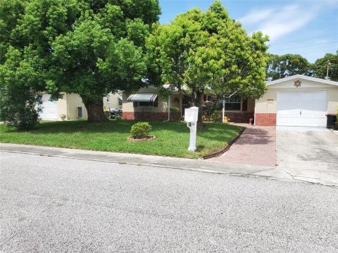 Front of house with extra wide driveway for additional parking for cars.