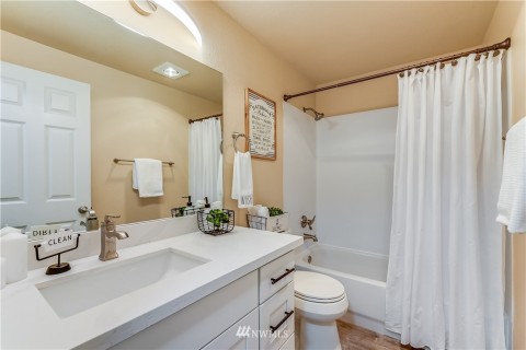 Updated main bathroom -new cabinet, quartz countertop, new toilet, all new chrome fixtures and new light fixture.